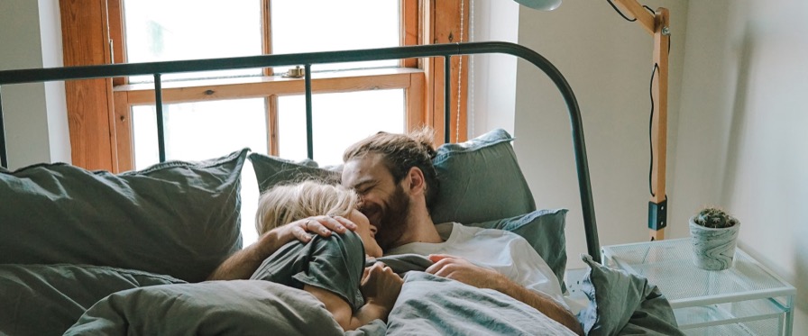 Couple sharing a tender forehead kiss